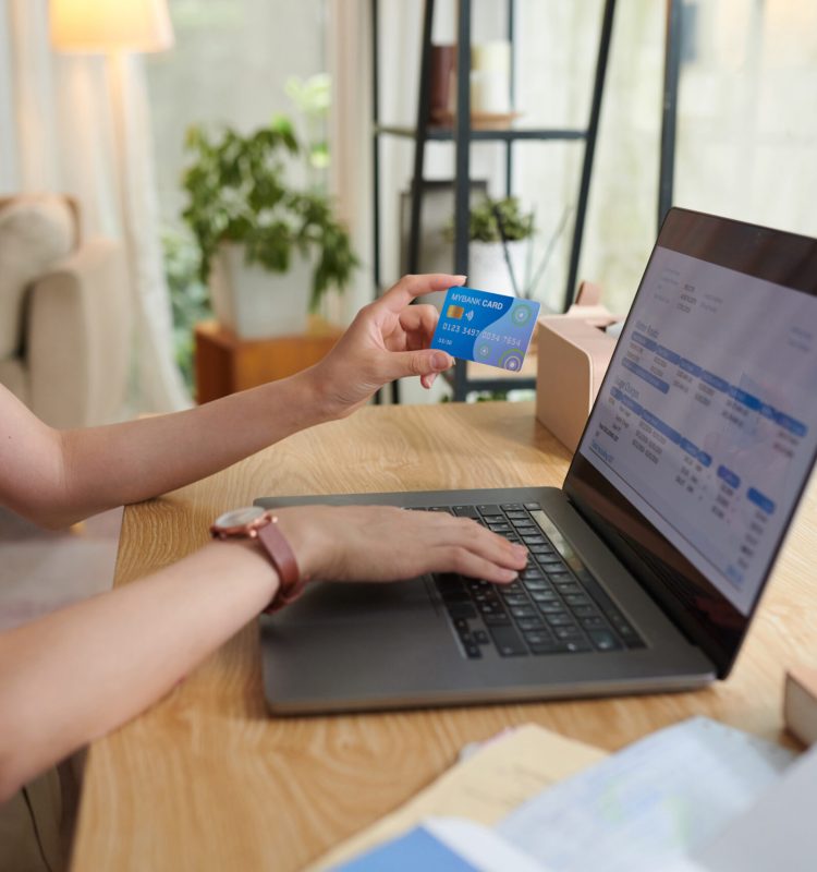 Woman paying for utility bills with credit card